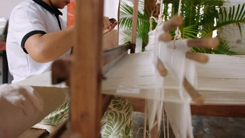 Woman weaving silk threads using a traditional wooden handloom. Womans hands Video stock 322769392