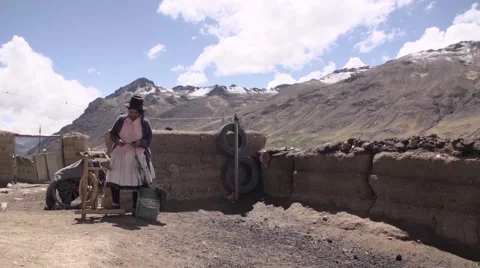 Woman weaving yarn on spinning wheel Stock Footage