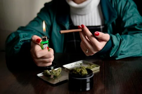 Woman weed marijuana joint burn with lighter Stock Photos