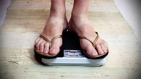 Woman on a weight. Stock Footage
