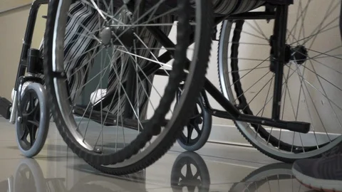 Woman with Wheelchair at Hospital Corridor Stock Footage