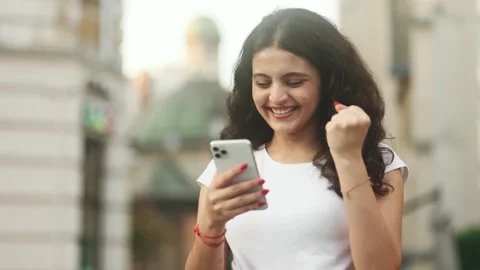 Woman while get notification and celebrate online win success reading great news Stock Footage 250480075