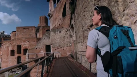 A woman while she is walking inside the Trajan Forum Stock Footage 247511258