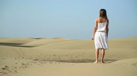 Woman in white dress standing in the desert HD Stock Footage
