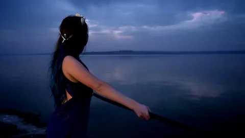 A woman with white patterns on her face stands at the railing against the Stock Footage 81323818