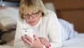 Woman with white smartphone lying on the bed and listening to music HD Footage