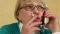 Woman with white smartphone speaks and smokes HD Footage