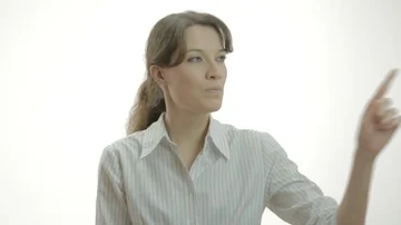 Woman in a white studio interacts with an interface on the invisible glass. Stock Footage 85904102