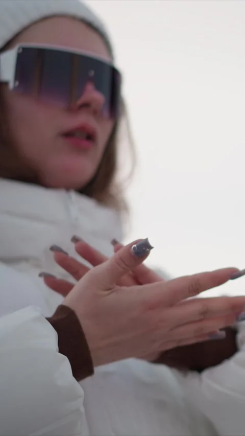 Woman in White Winter Jacket Adjusting Clothing Close Up with Sunglasses and Stock Footage 346795517