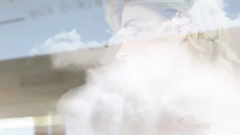 Woman at window, cloud thinning and revealing hands while tapping tablet, Stock Footage 333336458