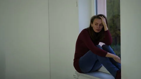 Woman on the window upset. Stock Footage 142138283