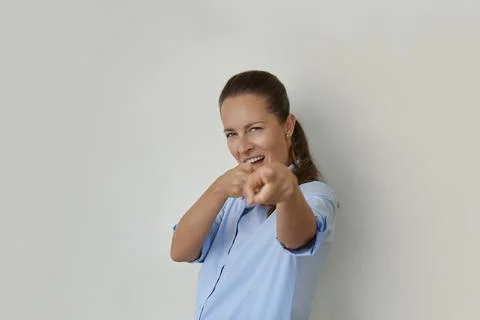 Woman winking and pointing with finger at camera Stock Photos