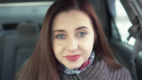 Woman winking while sitting in the car Stock Footage 87781676