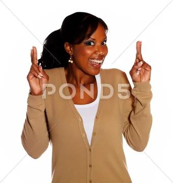 Woman with winning attitude crossing fingers Stock Photos