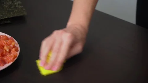 Woman wipes a table with a rag Stock Footage 128749025