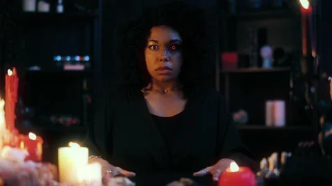 Woman witch practicing magic ritual, contacting ghosts, scary paranormal events Video stock 168312958