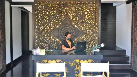 WOMAN WITHE MASK, WORKING BEHIND COUNTER, SPA RECEPTION DESK, HD Stock Photos