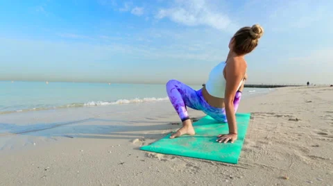 Woman without face doing stretching on the beach Stock-Footage 64024919