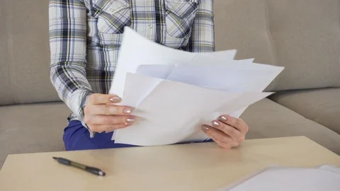 Woman at work with documents. Stockbeeldmateriaal 115348692