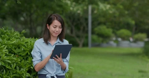 Woman work on tablet computer at park Video stock 132016031