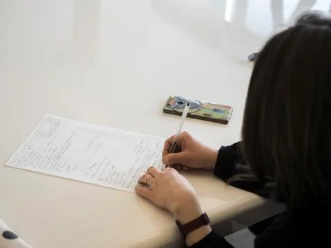 Woman at work taking notes Stock Photos