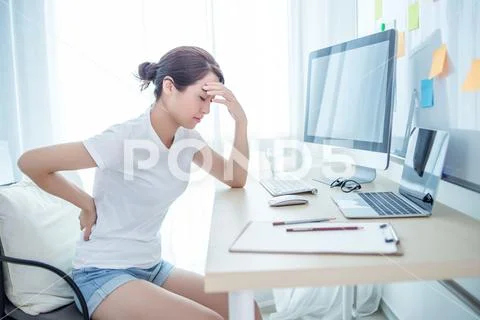 Woman worker back pain in office Stock Photos