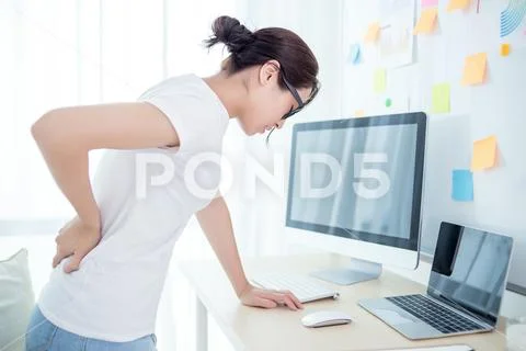 Woman worker back pain in office Stock Photos