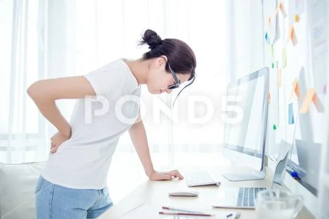Woman worker back pain in office Stock Photos