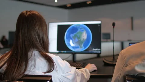 Woman worker using and working with display of computer monitor with Planet Stock Footage 154600842