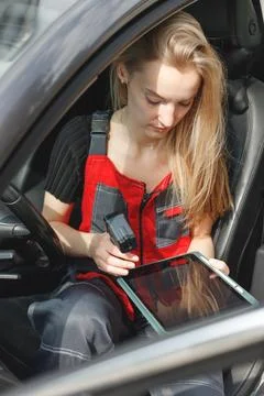 Woman Worker Using Digital Tablet With Empty Screen Sitting In Car doing On Stock Photos