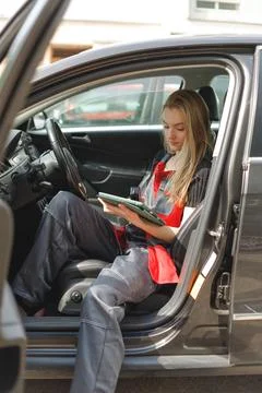 Woman Worker Using Digital Tablet With Empty Screen Sitting In Car doing On Stock Photos