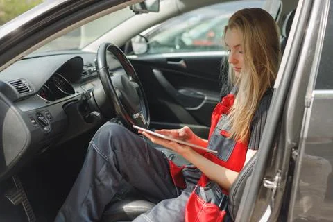 Woman Worker Using Digital Tablet With Empty Screen Sitting In Car doing On Stock Photos