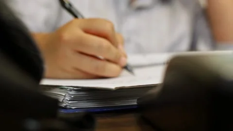 Woman working and taking notes at desk Video stock 136687262