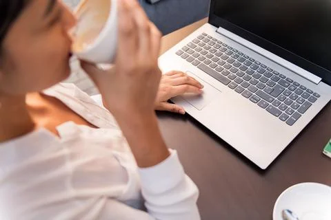 Woman working with computer and drinking coffee Stock Photos