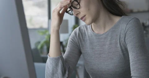 Woman working with a computer and feeling tired Stock Footage 154514523