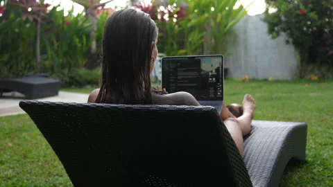 The woman is working on computer in beautiful backyard her Bali house Stock Footage 288834129