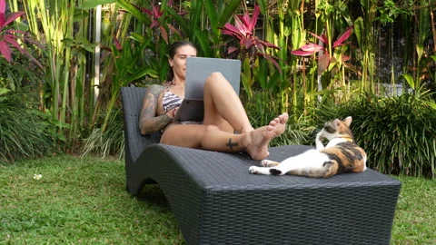 The woman is working on computer in beautiful backyard her Bali house Stock Footage 288867853
