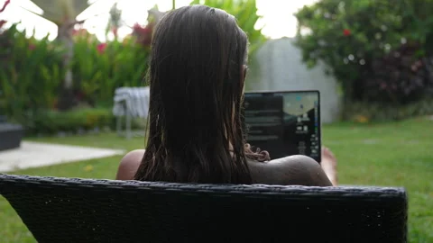 The woman is working on computer in beautiful backyard her Bali house Stock Footage 288926389