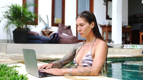 The woman is working on computer in beautiful backyard her Bali house Stock Footage 289108490