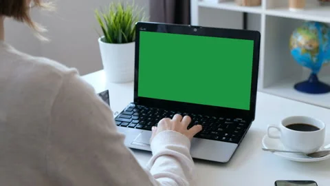 Woman working on a computer, green screen. Over the shoulder shot Stock Footage 104173589