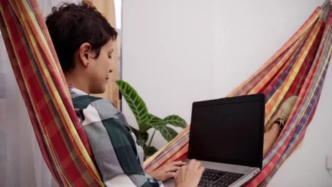 Woman working computer hammock Horizontal Video stock 280350228