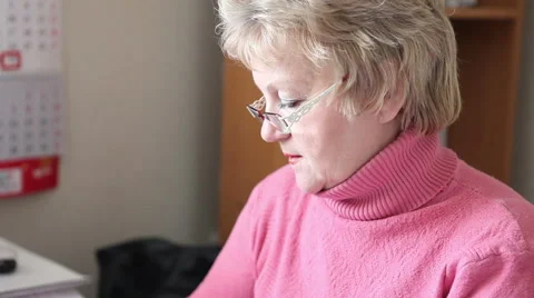 Woman working at a computer in the office Stock Footage 58866720