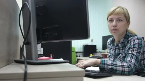 A woman working at a computer in the office Stock Footage 61145942