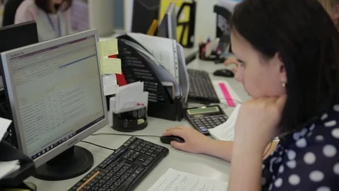 Woman working at computer in office Stock Footage 86247331