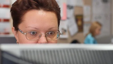 A woman working at a computer in the office. Stock Footage 116483929