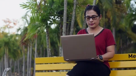 Woman working computer park Stock Footage 121504074