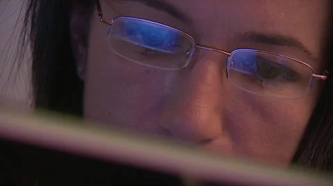 Woman working on computer, reflection in spectacles, close-up Stock Footage 6485356