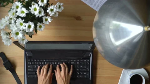 A woman working at a computer with smart watches and coffee. Dolly shot. Stock Footage