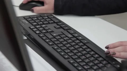 A woman working at a computer typing on the keyboard Stock Footage 65461958