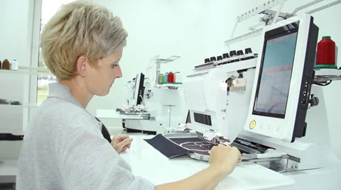 Woman working on computerized machine embroidery Stock Footage 31838353
